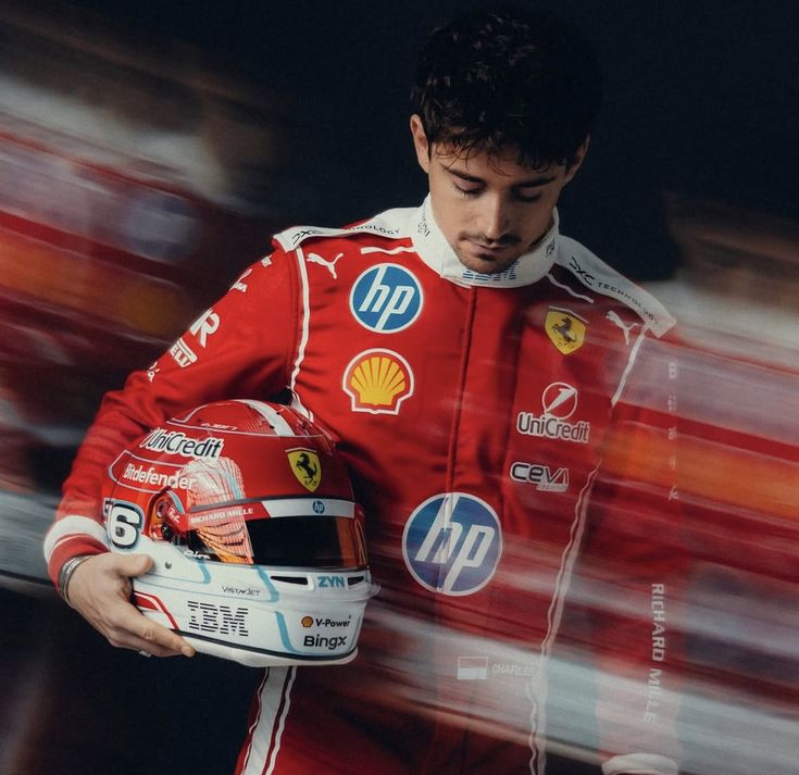 Formula 1 driver holding a helmet